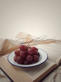 High angle view of grapes in bowl on table