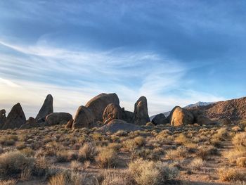 Rock formations on landscape against sky