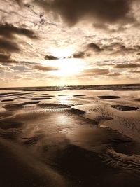 Scenic view of beach against sky during sunset