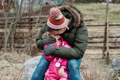 Candid portrait of playful father kissing his daughter outside