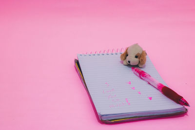 Close-up of pencil on table against pink background
