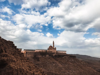 Low angle view of historical building against cloudy sky