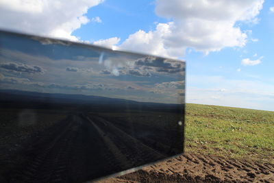 Close-up of field against sky