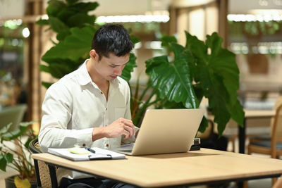 Businesswoman using laptop at table