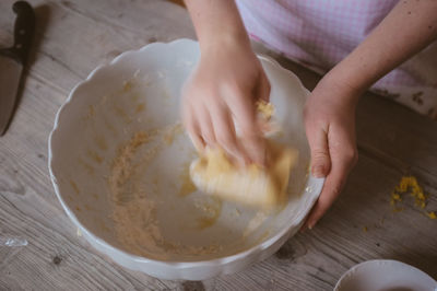 Close-up of person preparing food in bowl