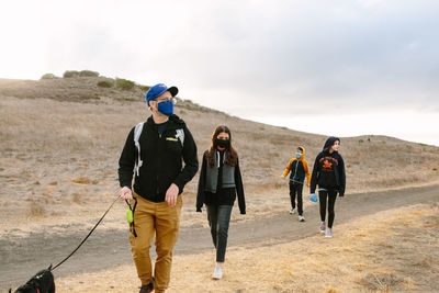 Rear view of people walking on road