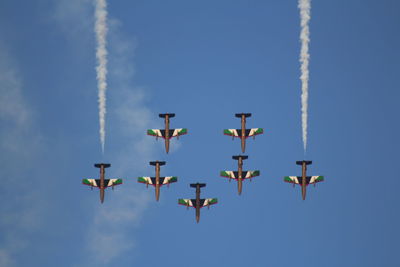 Low angle view of airshow against sky