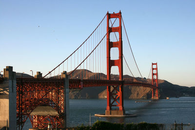 Golden gate bridge in city against clear sky