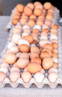 Egg crates of brown and white eggs at a local farmers market from organic chickens.