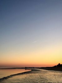 Scenic view of sea against clear sky during sunset