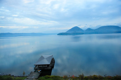 Scenic view of lake against cloudy sky