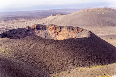 Scenic view of a volcano crater mountains against sky