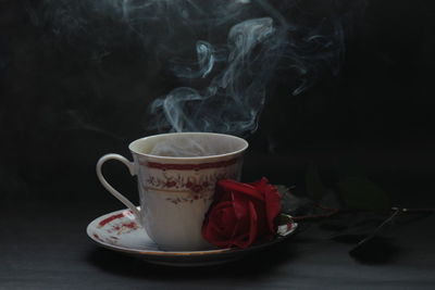 Close-up of tea cup against black background