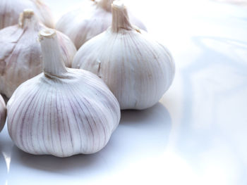 Close-up of white garlic on table