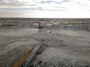 Pier in sea during high tide against sky