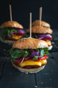 Close-up of fresh burgers on dark background