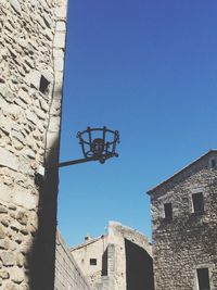 Low angle view of buildings against clear blue sky