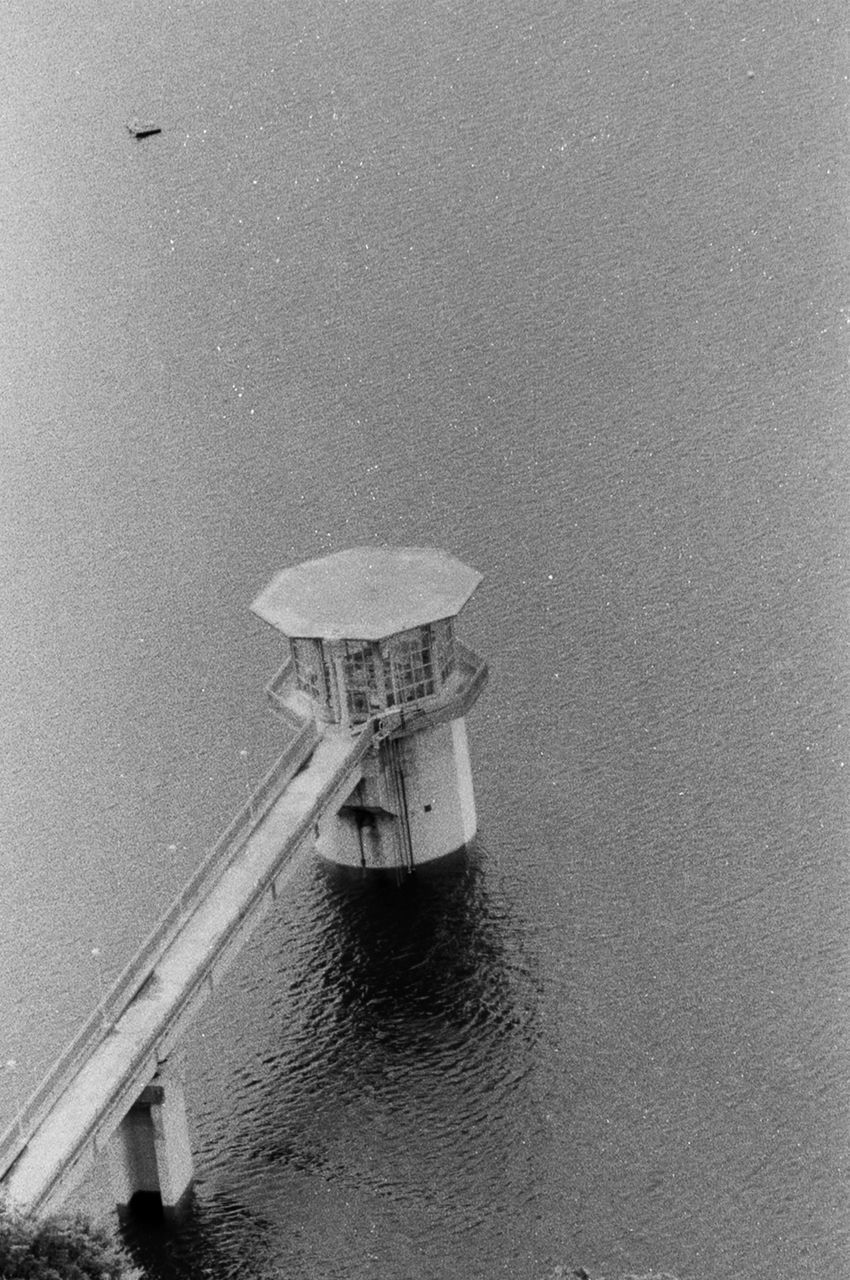 HIGH ANGLE VIEW OF LIGHTHOUSE ON SEA SHORE