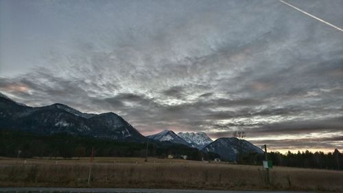 Scenic view of mountains against cloudy sky