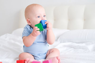 Portrait of cute baby boy sleeping on bed at home