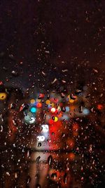 City seen through wet windshield during rainy season