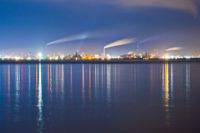 Smoke emitting from factory against sky at night