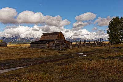 Houses on field against sky