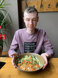 Portrait of teenage girl sitting on table