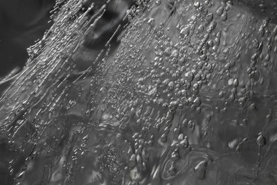 Close-up of wet glass window during rainy season