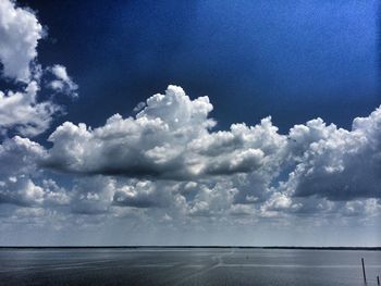 Scenic view of sea against cloudy sky