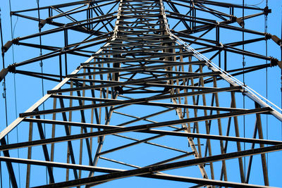 Low angle view of bridge against blue sky