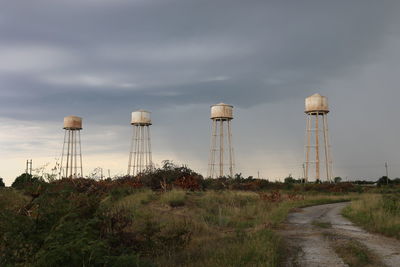 Water towers at the sunflower ammunition plant with a storm rolling in