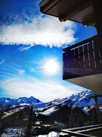 Low angle view of buildings against sky during winter