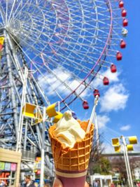 Low angle view of ferris wheel against sky