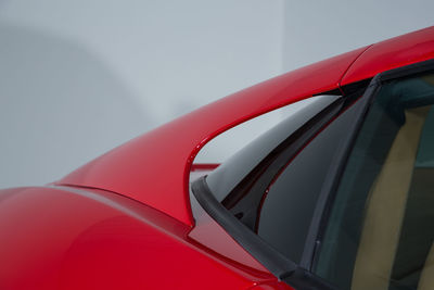 Close-up of red car against sky