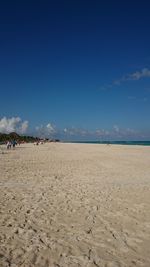 Scenic view of beach against blue sky