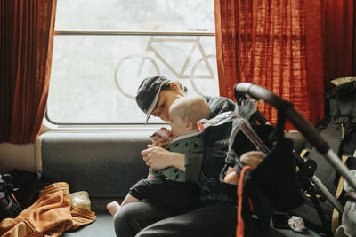 Woman traveling with baby by train