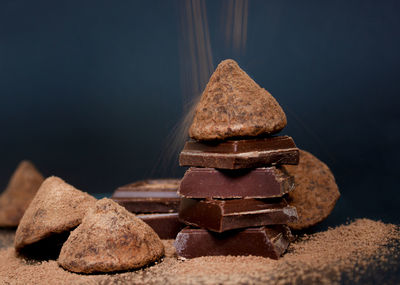 Close-up of cookies on table against black background