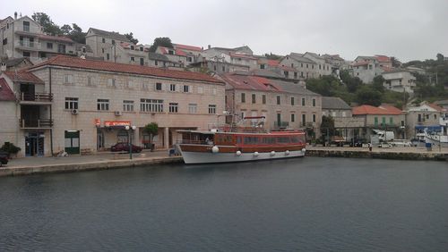 View of residential buildings against cloudy sky