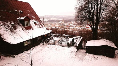 Snow covered houses and trees during winter