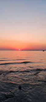 Scenic view of sea against orange sky