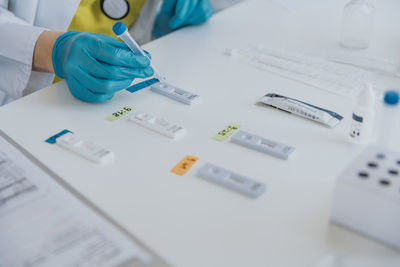 Expert dropping sample on test cassettes while working at examination room