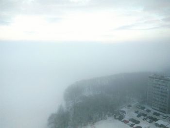 Scenic view of snow covered landscape in foggy weather