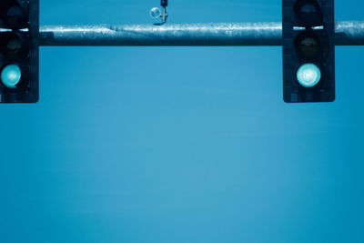 Low angle view of telephone pole against blue sky