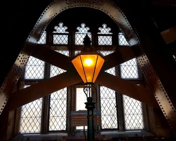 Low angle view of illuminated lamp in building