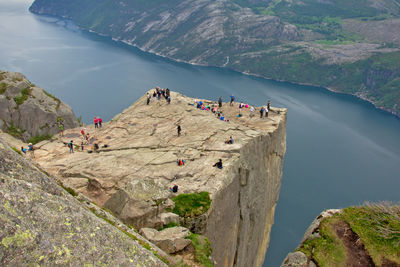 High angle view of people on cliff by river