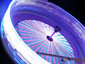 Low angle view of illuminated ferris wheel