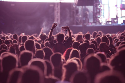 Rear view of people enjoying at music concert