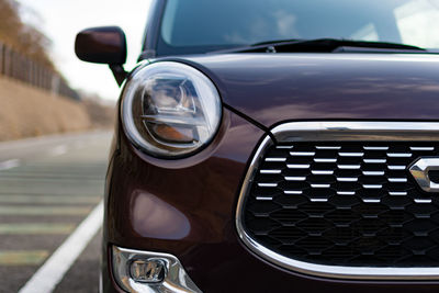 Close-up of car on road