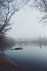 Scenic view of lake against sky during winter